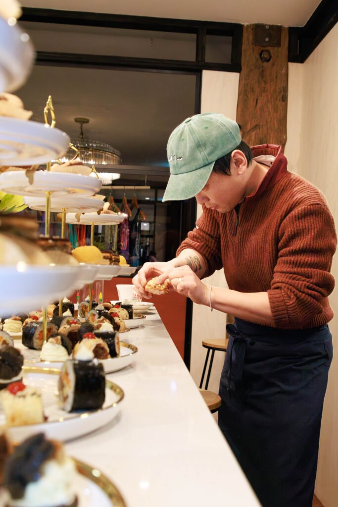 Hankyul carefully placing the pastries on the stands