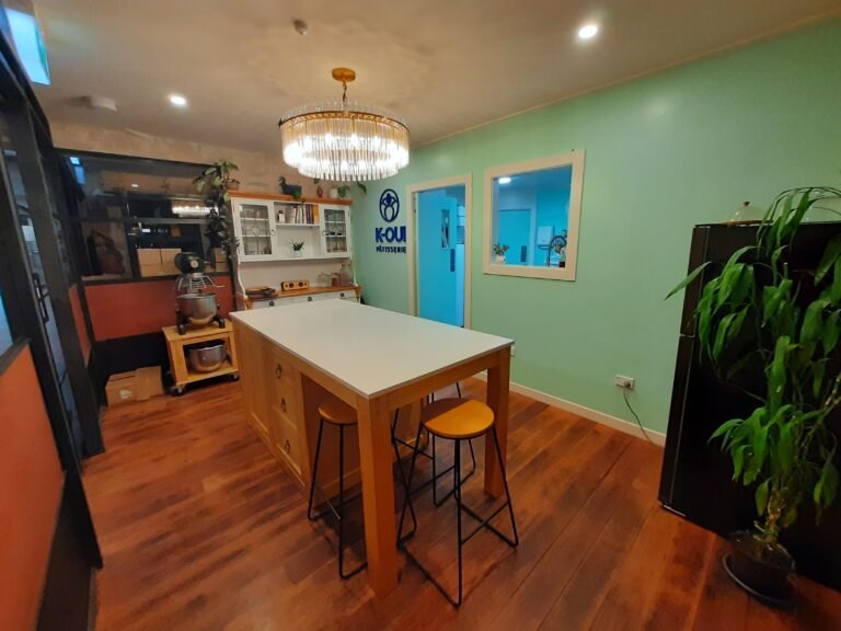 Our showroom kitchen with a beautiful marble bench in the middle as well as our Chandelier.