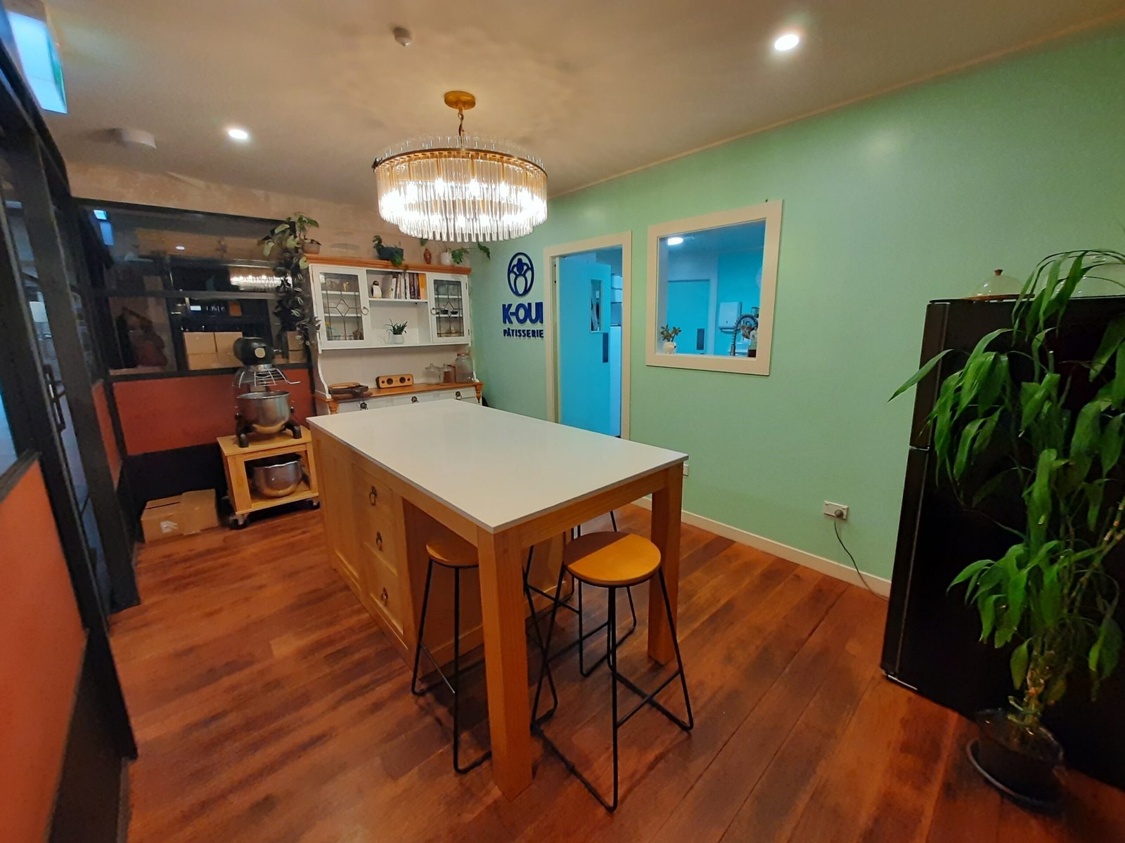Our showroom kitchen with a beautiful marble bench in the middle as well as our Chandelier.